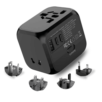 Black universal travel adapter with multiple plug tips on a white background