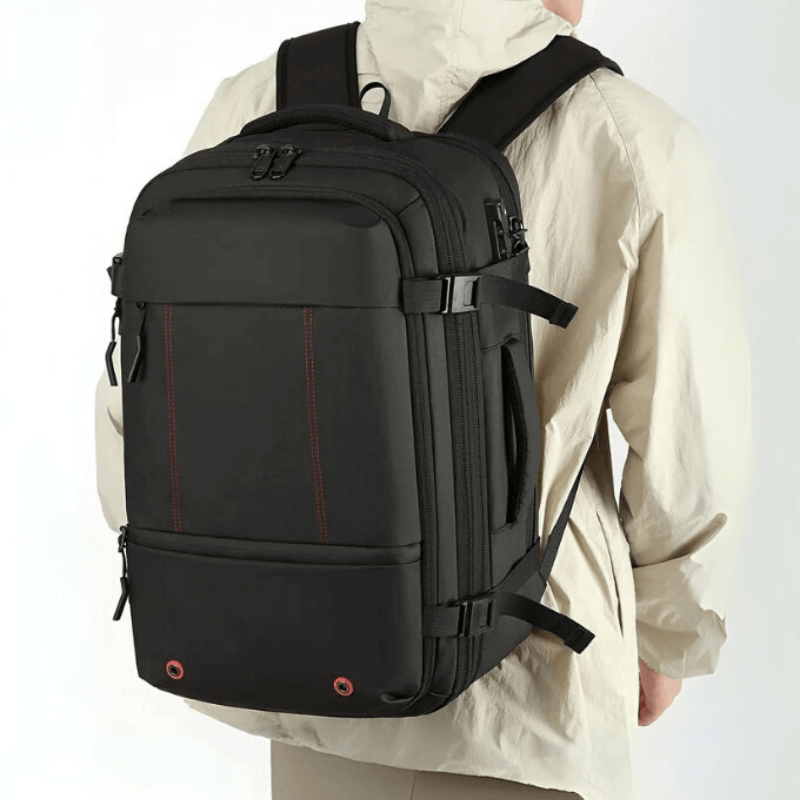 Person wearing a black backpack with red accents on a white background