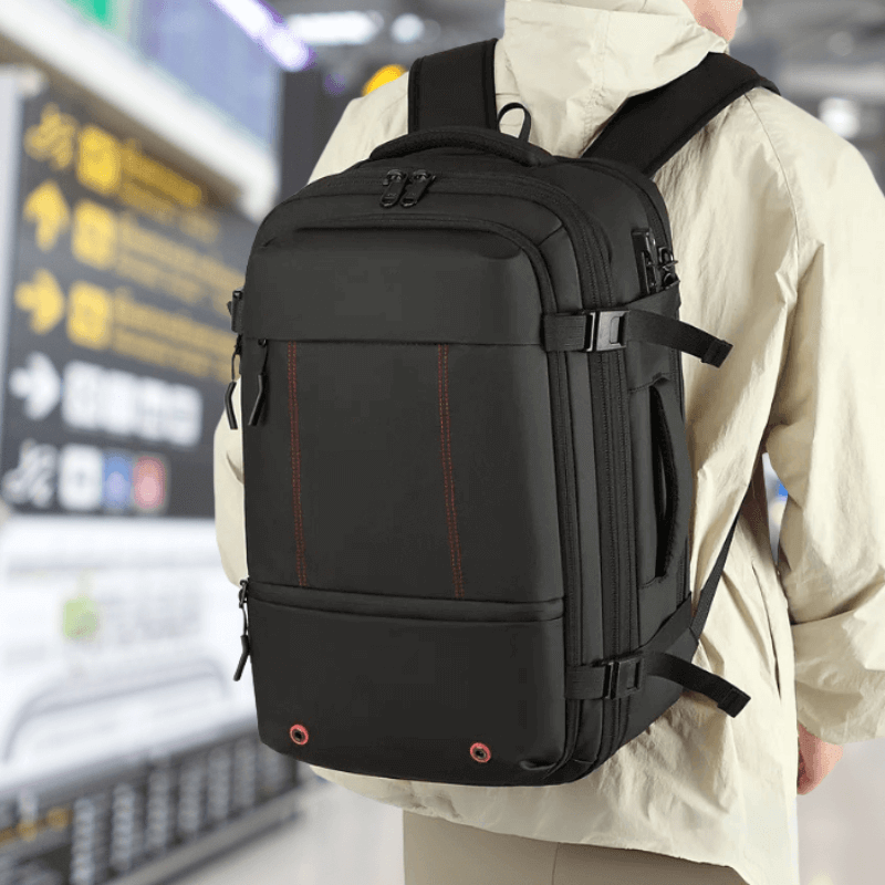 Person wearing a black backpack in an airport setting